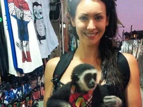 Natalie Glebova mugs with endangered gibbon